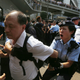 A policewoman tries to stop an Anti-Occupy protester from breaking through a police cordon to attack pro-democracy protesters.